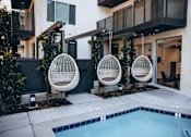 Thumbnail 10 of 76 - Pool with an outdoor hanging rattan egg chairs