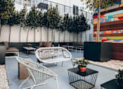 Thumbnail 13 of 76 - Peaceful setting created by ivy-draped walls, with custom graffiti art wall, interaction-focused lounge areas