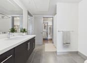 Thumbnail 13 of 40 - A bathroom with a sink, mirror, and towel rack.