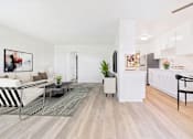 Thumbnail 2 of 73 - A modern living room with a white sofa and a grey rug.