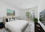 Thumbnail 8 of 16 - A bedroom with a large bed and a painting on the wall.