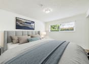 Thumbnail 4 of 70 - A bedroom with a large bed and a picture on the wall.