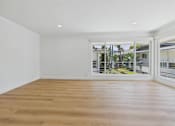 Thumbnail 108 of 228 - A room with wooden flooring and white walls.