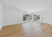 Thumbnail 107 of 228 - A room with wooden flooring and white walls.