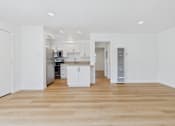 Thumbnail 104 of 228 - A kitchen with white cabinets and a wooden floor.