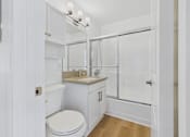 Thumbnail 118 of 228 - A white bathroom with a toilet, sink, and shower.