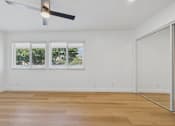 Thumbnail 115 of 228 - A room with a ceiling fan and a sliding glass door.