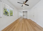 Thumbnail 116 of 228 - A room with a ceiling fan and wooden flooring.