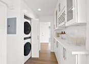 Thumbnail 14 of 135 - a white laundry room with a washer and a dryer