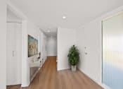 Thumbnail 13 of 135 - a living room with white walls and a plant