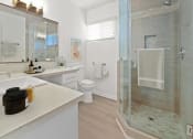 Thumbnail 21 of 135 - a bathroom with a shower and a sink and a toilet