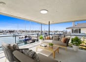 Thumbnail 12 of 135 - a living room with a balcony overlooking a marina