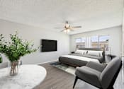 Thumbnail 8 of 38 - A modern bedroom with a large bed, a flat screen TV, and a ceiling fan.