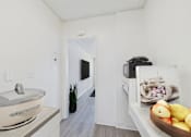 Thumbnail 10 of 38 - A bathroom with a tub, a plant, and a bowl of fruit.