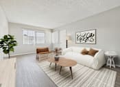Thumbnail 4 of 91 - A living room with a white couch, a wooden coffee table, and a large plant.