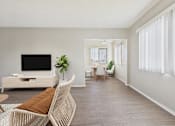 Thumbnail 3 of 91 - A living room with a white sofa and a television.