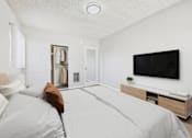 Thumbnail 7 of 91 - A bedroom with a large bed and a flat screen TV mounted on the wall.