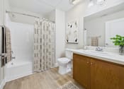 Thumbnail 44 of 53 - A bathroom with a toilet, sink, and shower.