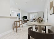 Thumbnail 18 of 53 - A modern dining room with a round table and chairs.