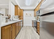Thumbnail 15 of 53 - A kitchen with wooden cabinets and stainless steel appliances.
