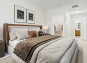 Thumbnail 20 of 53 - A bedroom with a large bed and two framed pictures on the wall.
