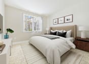 Thumbnail 31 of 53 - A bedroom with a large bed and a window with blinds.