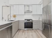 Thumbnail 38 of 163 - A modern kitchen with stainless steel appliances and white cabinetry.