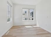 Thumbnail 75 of 163 - A room with a window and a wooden floor.