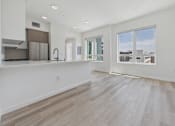 Thumbnail 53 of 163 - A spacious kitchen with a refrigerator, sink, and a window overlooking the city.
