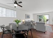 Thumbnail 3 of 34 - a living room with a dining room table and a ceiling fan