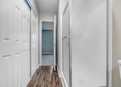 Thumbnail 43 of 64 - a bathroom with white cabinets and a door to a closet