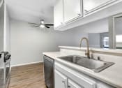 Thumbnail 17 of 61 - a kitchen with a sink and a ceiling fan