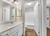 Thumbnail 23 of 61 - a bathroom with a sink and a toilet and a mirror