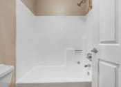 Thumbnail 56 of 61 - a white bathroom with a tub and a sink