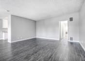 Thumbnail 27 of 52 - an empty living room with wood floors and white walls