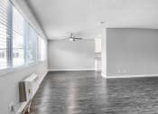 Thumbnail 24 of 52 - an empty living room with a large window and a ceiling fan