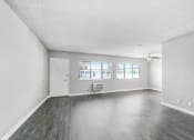 Thumbnail 25 of 52 - an empty living room with white walls and wood floors