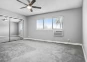 Thumbnail 30 of 52 - an empty living room with a ceiling fan and a window