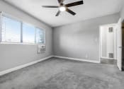 Thumbnail 29 of 52 - an empty living room with a ceiling fan and a window