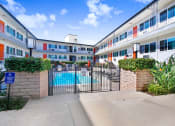 Thumbnail 12 of 52 - the pool area of a building with a gate and a swimming pool