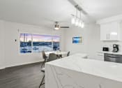 Thumbnail 89 of 135 - a kitchen with a marble counter top and a table with chairs