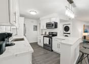 Thumbnail 91 of 135 - a kitchen with white cabinets and stainless steel appliances