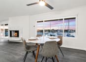 Thumbnail 84 of 135 - a living room with a table and chairs and a fireplace