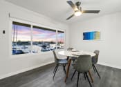 Thumbnail 86 of 135 - a dining room with a large window and a table and chairs