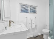 Thumbnail 93 of 135 - a bathroom with a sink and a toilet and a shower