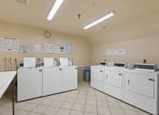 Thumbnail 52 of 52 - the washer and dryer machines are lined up in the laundry room of an