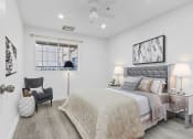 Thumbnail 24 of 52 - a white bedroom with a bed and a window