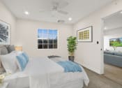 Thumbnail 34 of 52 - a bedroom with a bed and a ceiling fan