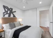 Thumbnail 31 of 52 - a bedroom with a large bed and a ceiling fan