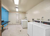 Thumbnail 14 of 22 - A laundry room with a washer and dryer.